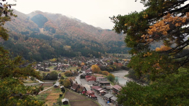 Aerial view and dolly forward of Shirakawago village in autumn season, Gifu, Japan.