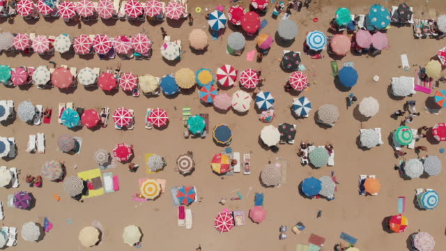 Aerial View of a Beach With Crowd Enjoying Sea