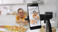 istock 4K Asian man using smartphone with internet advertising his bakery on social media 1339554578