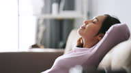 istock Asian Woman relaxing at Sofa 1288434083