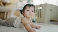 istock Baby girl crawling on the floor at home 1331657557
