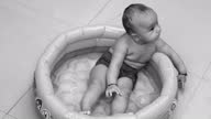 istock Baby playing in bathtub 1307161233