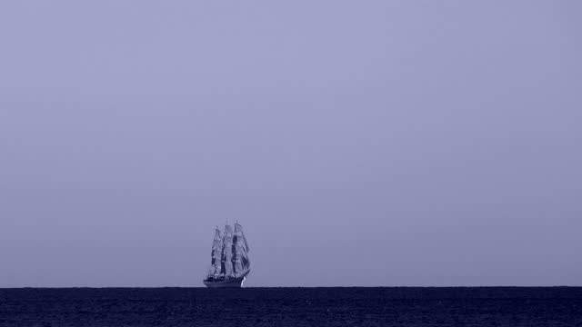 background - an old sailing ship in the night