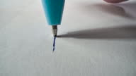 istock Ballpoint pen writes or draws on paper 1220840569