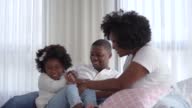 istock Black family playing in bed 1399950631