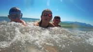 istock Brothers and sister having fun splashed in sea 1192949304