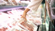 istock Buying meat at supermarket. 620858854