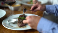 istock Close up of man cutting a delicious steak and eating it 1016109378
