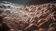 istock Close up of seeds of coffee. Fragrant coffee beans are roasted smoke comes from coffee beans. 1269721081