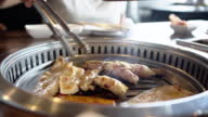 istock Close-up a woman hand cooking grilled pork meat bbq. Korean food 1409978284