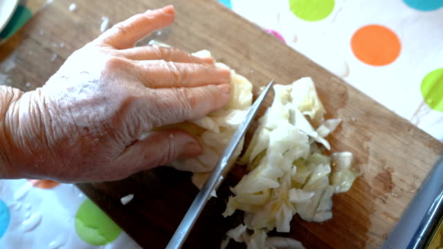 Close-up footage of cutting sour cabbage
