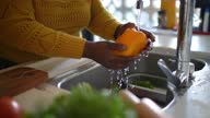 istock Close-up of a senior woman's hands washing a bell pepper at home 1356441121
