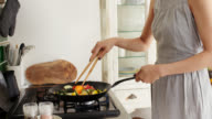 istock Close-up of a young woman cooking stir fry in wok 1152248929