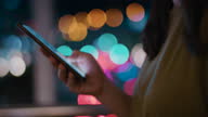 istock Close-up:Hand  using smart phone at night in the City 1345762833