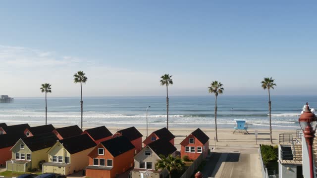 Cottages in Oceanside California USA. Beachfront bungalows. Ocean beach palm trees. Lifeguard tower.