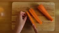 istock Cutting carrots on a chopping board 1280393753