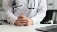 istock Doctor neurologist holding percussion hammer in clinic closeup 4k movie 1368000501