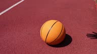 istock Dribbling basketball ball on red court 1332331356