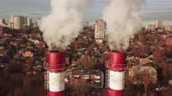istock from the boiler room tube goes white steam, smoke into the sky. Cityscape. 1342695714