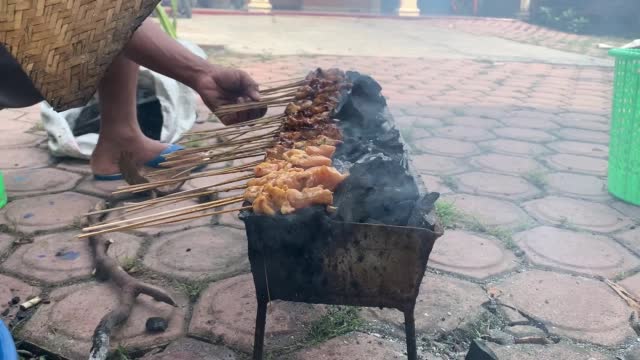 Goat satay being grilled on charcoal