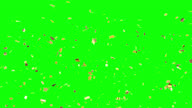 istock Golden confetti stars falling on the green screen background with an alpha channel. 1302330776