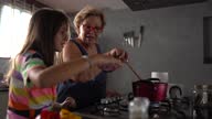 istock Grandmother cooking with granddaughters at home 1325121129