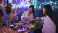 istock Group of young asian friends  eating korean barbecue. 1355217280