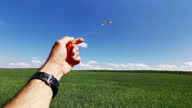 istock Hand flying kite in clear blue sky, point of view. Childhood fun. 1324758996