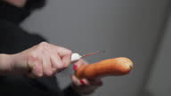 istock Hand slicing peeled carrot shavings for cooking, slow motion 1296592054