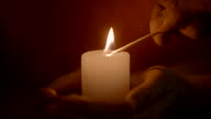istock Hands lighting candle with matchstick 1300539377