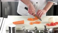 istock Hands of chef chopping carrot. 1358080970