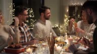 istock happy friends having christmas dinner at home 1276587556