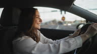 istock Happy woman driving home from work 1366268885