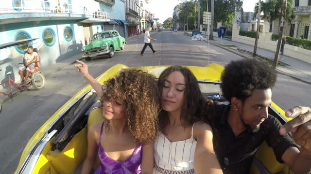 Havana taxi historic downtown old city mixed race friends tourist journey