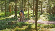 istock TS Husband and wife talking while on a hike in the forest with their dog 1335033362