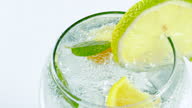 istock Ice Cold Mineral Soda Water with Lemon Fruit Slices and Fresh Mint Leaves 100 fps High Speed Video 1331561965
