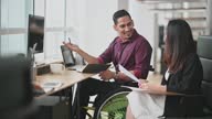 istock Indian Businessman in wheelchair having discussion with his female Chinese colleague in creative office 1330736181