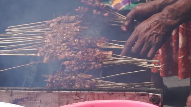Indonesian roasting sate. Sate is one of traditional Indonesian food which served with peanut sauce