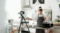 istock Japanese female cook talkis to her audience during virtual cooking class event held online 1324071719