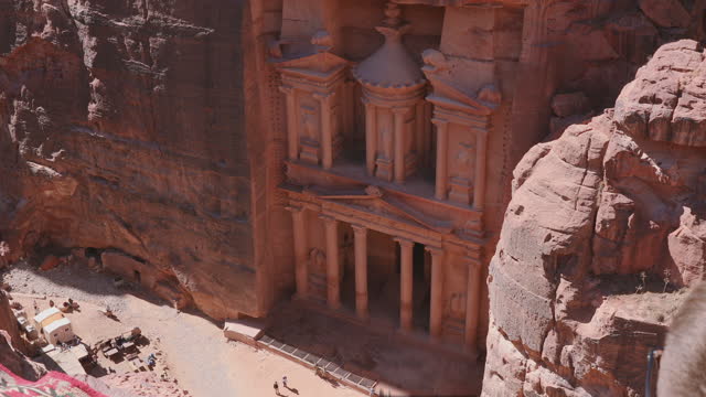 Male traveler exploring the ancient world of Petra in Jordan from above