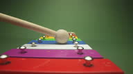 istock Man playing rainbow metallophone with a wooden percussion mallet 1296926942
