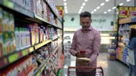 istock Man scanning product using smartphone in the supermarket 1312490875