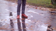 istock man walking on a wet bike road 1285319874