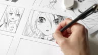 istock Manga style. The artist draws anime comics on paper. The illustrator creates sketches for the book. 1342849704
