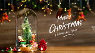 istock Merry Christmas and Happy new year xmas tree and santa claus in glass dome decor with bauble reindeer,pine cone tinsel at wood background.Table Banner space for display product 1336978971