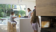 istock Modern contemporary family in kitchen making breakfast 939047970