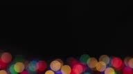 istock Mysteriously lit colored Christmas lights on a black background, copy space. 1359257265