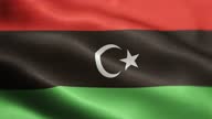 istock National Flag of Libya Animation Stock Video - Libyan Flag Waving in Loop and Textured 3d Rendered Background - Highly Detailed Fabric Pattern and Loopable - State of Libya Flag 1357782270