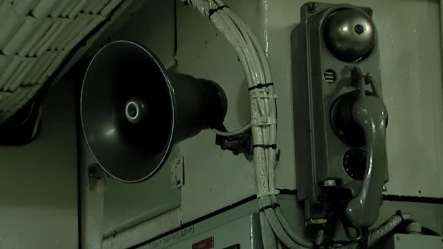 Old Loudspeaker and Vintage Telephone in the Engine Room on Board a Tugboat. Close Up.