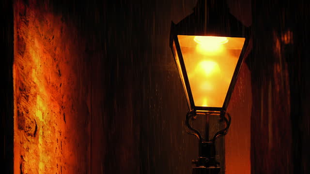 Old Street Lamp Between Buildings On Rainy Night